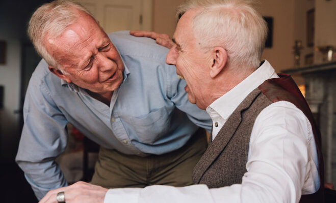 Two senior men laughing together