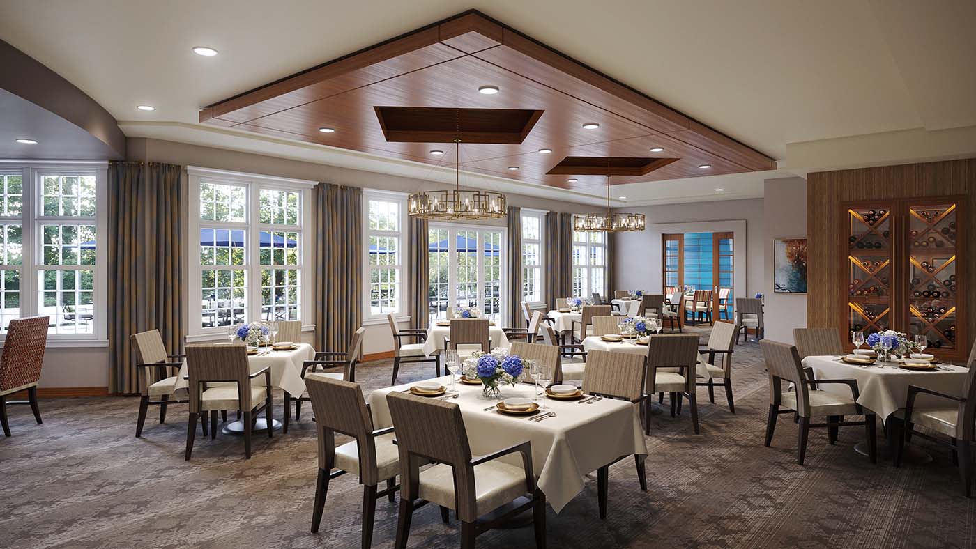 A gourmet dining room with white table linens within a senior living community