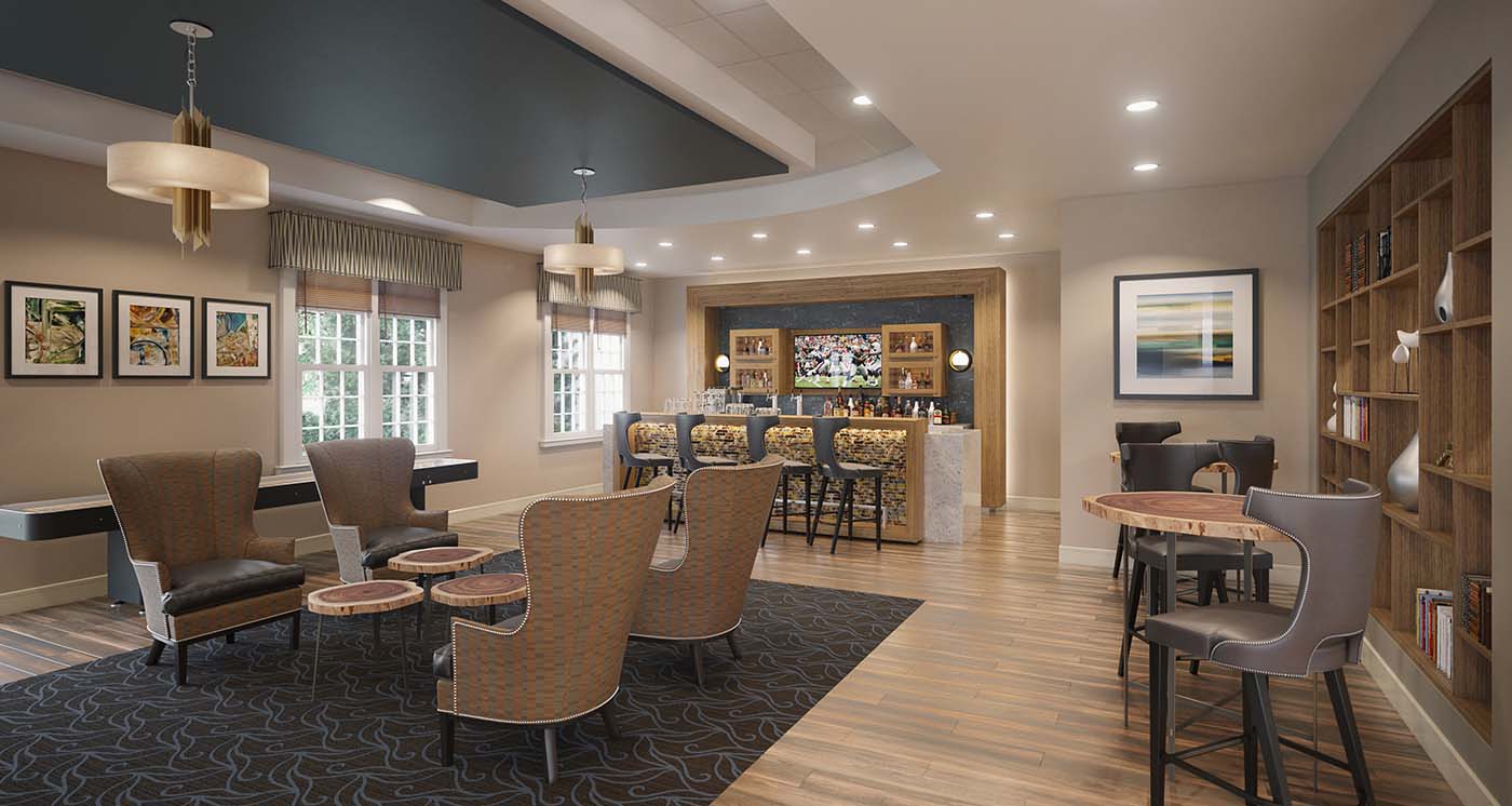 View of a library within a senior living community including chairs for conversation and a bar