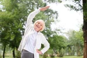 Senior woman stretching. Stretching is especially beneficial for seniors who may be dealing with compromised mobility, flexibility and posture.