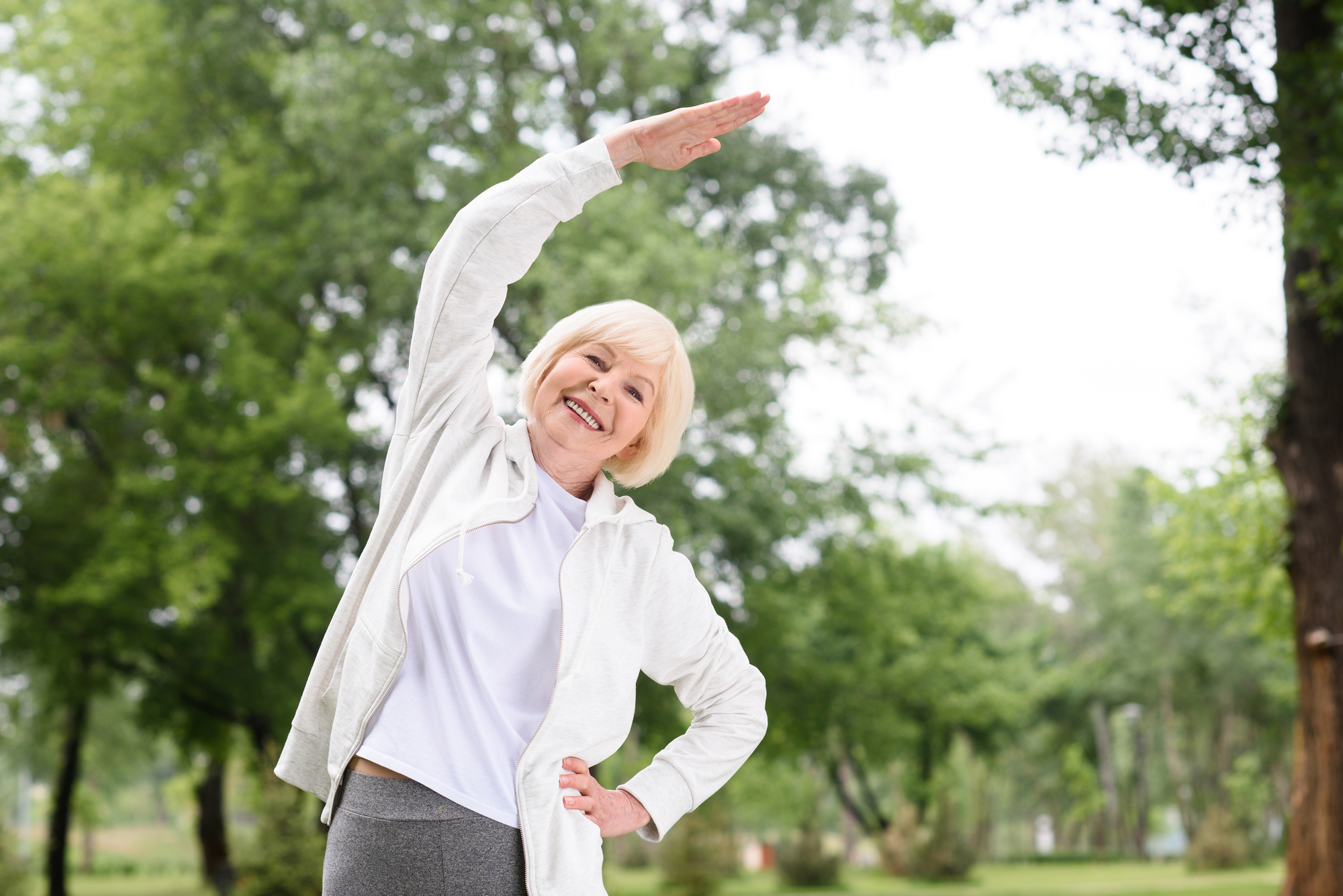 Senior woman stretching. Stretching is especially beneficial for seniors who may be dealing with compromised mobility, flexibility and posture.