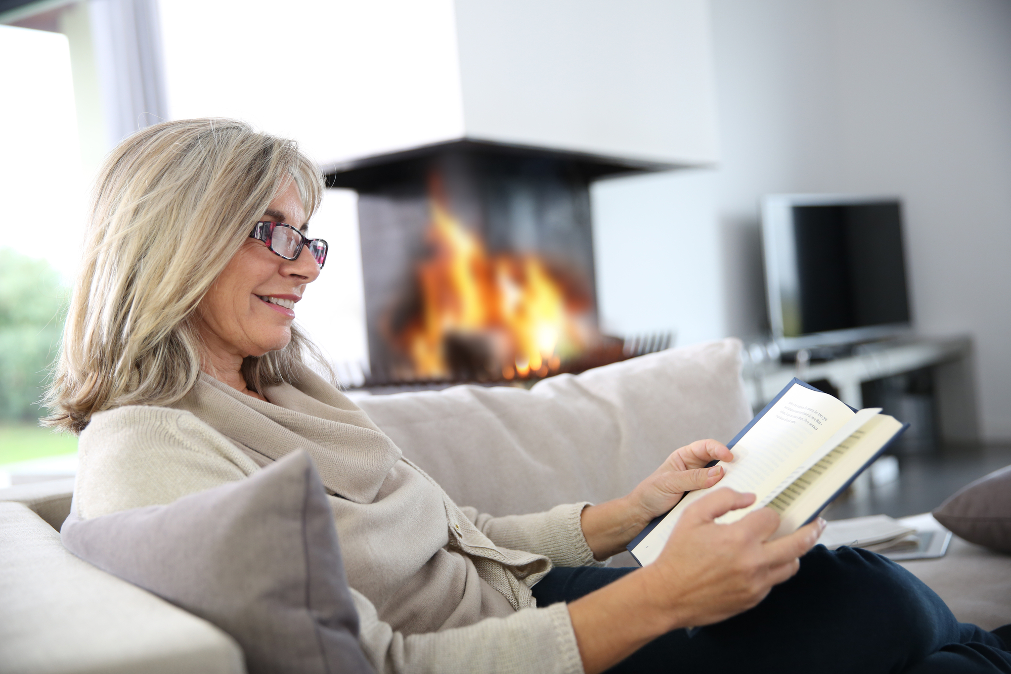 Woman reading a book in advance of her book group.