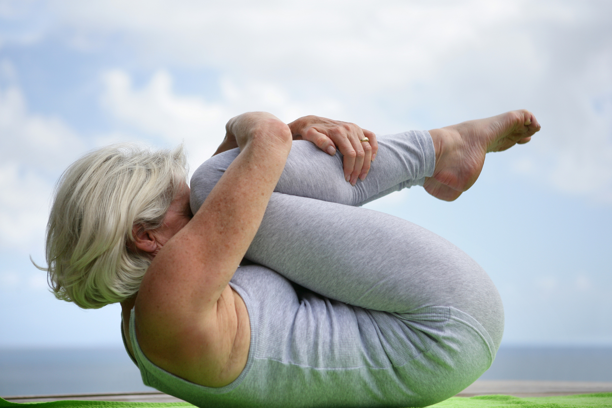 Senior woman holding a yoga pose.
