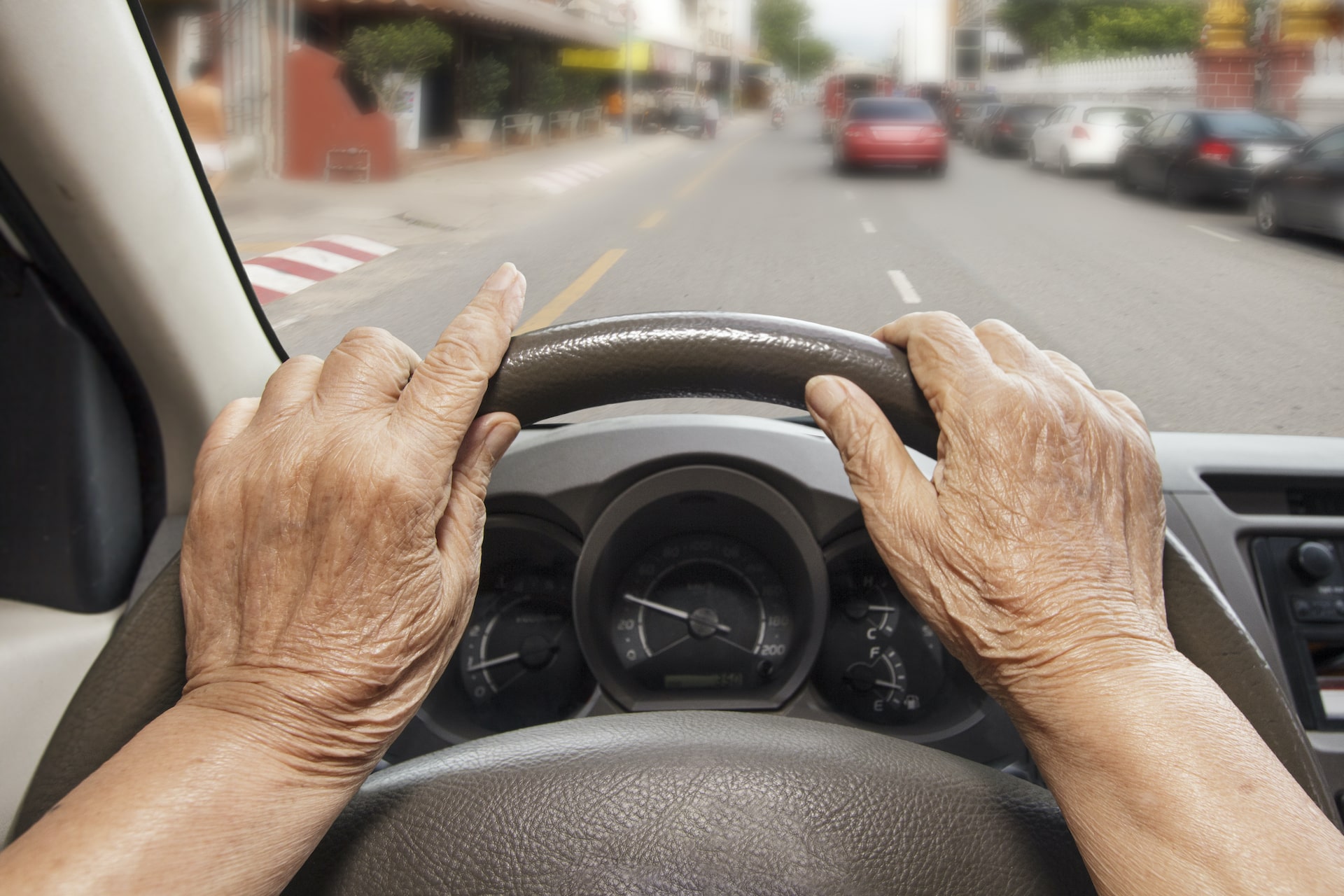 Image of hands on a steering wheel.