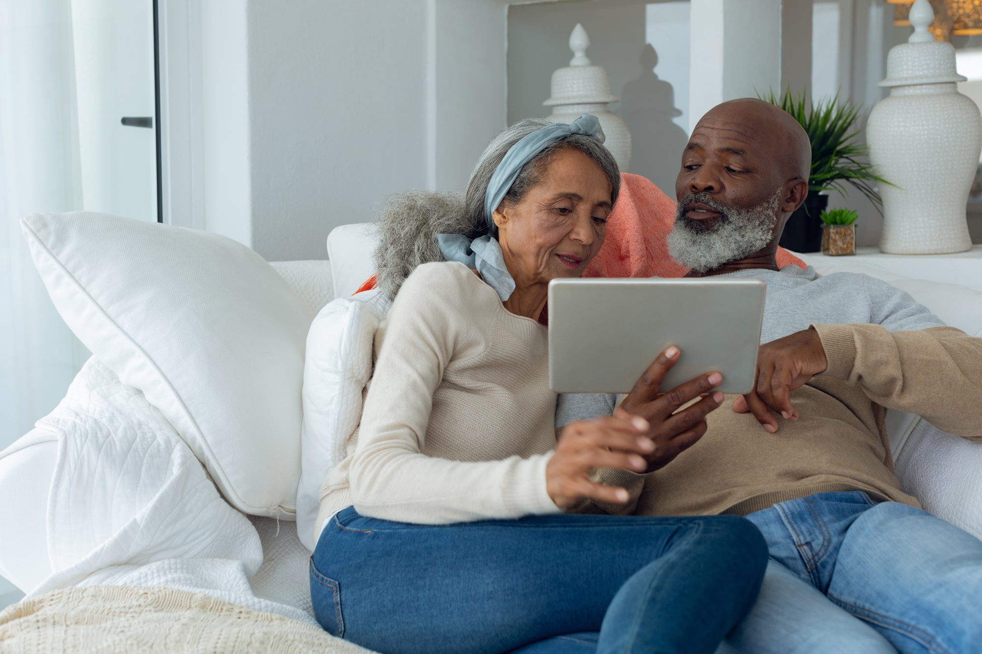 Senior couple on a tablet looking at healthcare apps.