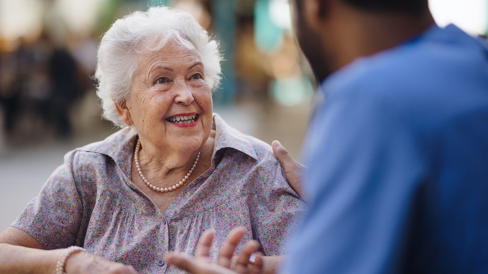 Senior woman speaking with her caregiver
